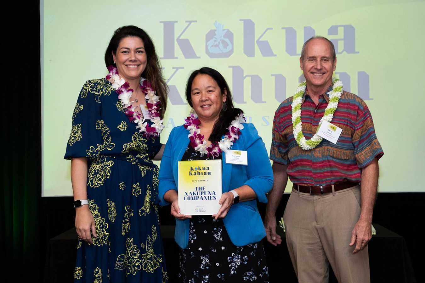 Nakupuna team - jeannin jeremiah and cariann ah loo with the pacific business news' kōkua kahiau award. This image is featured on the nakupuna companies website.